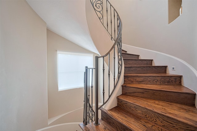 staircase with lofted ceiling