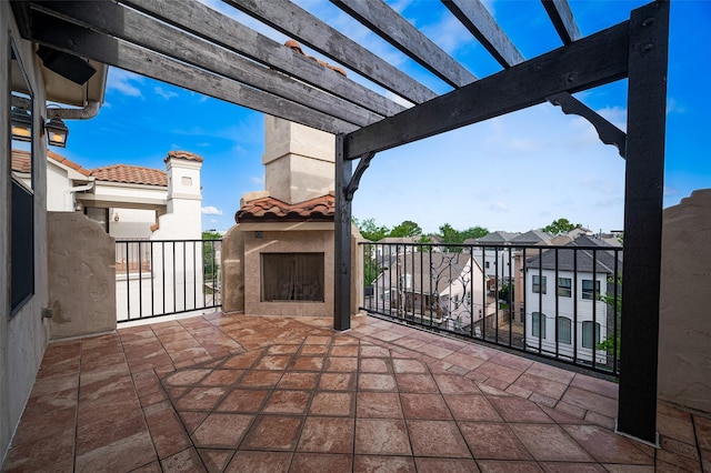 view of patio with a pergola and a balcony