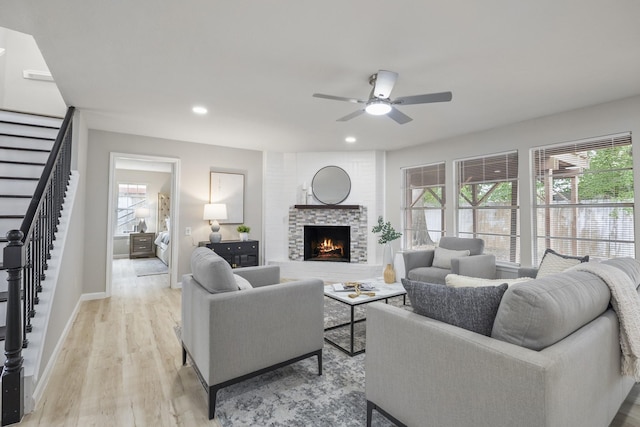1819 Redwood Ct, Sugar Land, TX 77498 - living area featuring light wood-type flooring, stairway, a healthy amount of sunlight, and ceiling fan