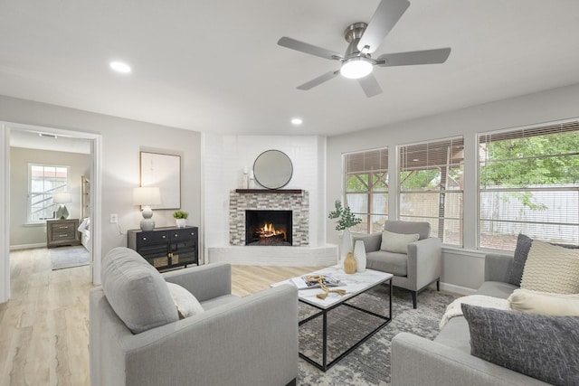 1819 Redwood Ct, Sugar Land, TX 77498 - living area with light wood-type flooring, recessed lighting, ceiling fan, a brick fireplace, and baseboards