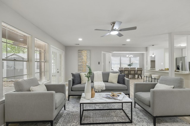 1819 Redwood Ct, Sugar Land, TX 77498 - living area featuring light wood-style flooring, recessed lighting, and ceiling fan with notable chandelier
