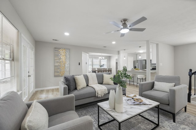 1819 Redwood Ct, Sugar Land, TX 77498 - living area with recessed lighting, light wood finished floors, visible vents, and ceiling fan with notable chandelier