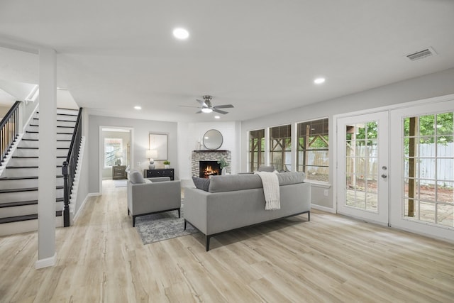 1819 Redwood Ct, Sugar Land, TX 77498 - living room with a ceiling fan, light wood-style flooring, baseboards, visible vents, and stairs