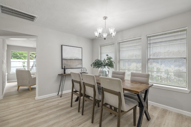 1819 Redwood Ct, Sugar Land, TX 77498 - dining space with baseboards, light wood-type flooring, an inviting chandelier, and visible vents