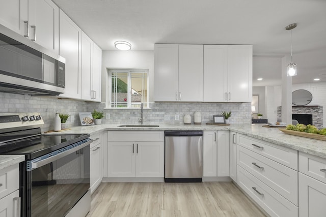 1819 Redwood Ct, Sugar Land, TX 77498 - kitchen with backsplash, white cabinetry, stainless steel appliances, and a sink
