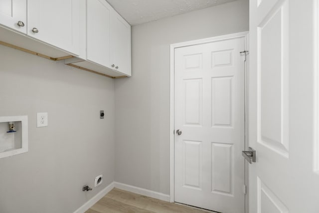 1819 Redwood Ct, Sugar Land, TX 77498 - laundry room featuring light wood-style flooring, baseboards, washer hookup, hookup for an electric dryer, and cabinet space