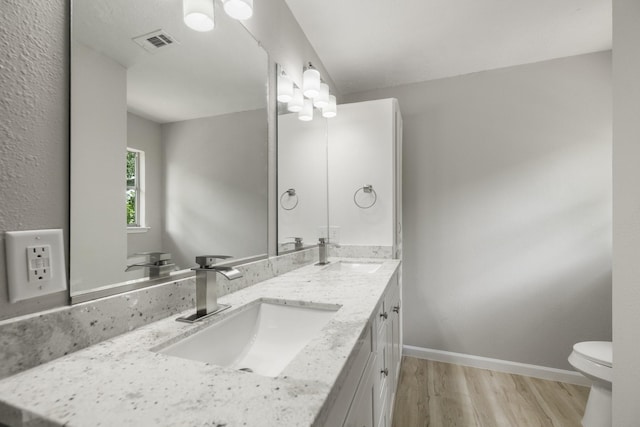1819 Redwood Ct, Sugar Land, TX 77498 - bathroom featuring a sink, toilet, visible vents, and wood finished floors