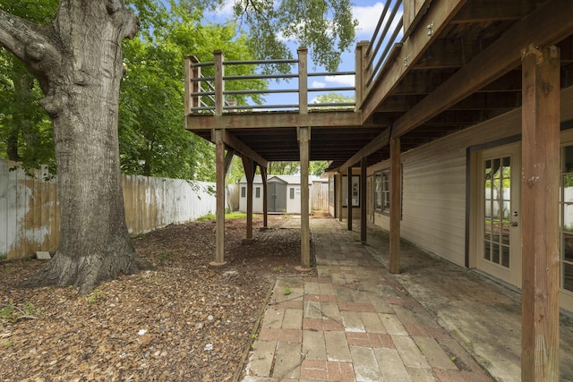 1819 Redwood Ct, Sugar Land, TX 77498 - view of patio featuring an outdoor structure, a fenced backyard, and a storage unit