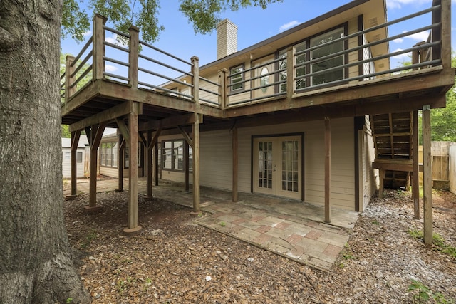 1819 Redwood Ct, Sugar Land, TX 77498 - rear view of house featuring a patio area, a chimney, french doors, and a deck