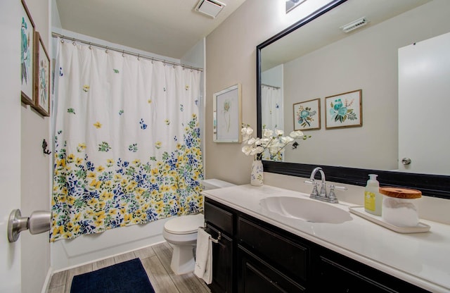 14022 Cypress Falls Dr, Cypress, TX 77429 - bathroom featuring toilet, vanity, wood finished floors, and shower / bathtub combination with curtain