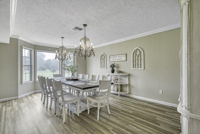 1985 Eastridge Ln, Madisonville, TX 77864 - dining room with a chandelier, visible vents, wood finished floors, and baseboards