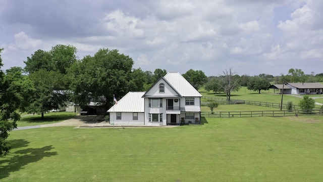 1985 Eastridge Ln, Madisonville, TX 77864 - back of house featuring a lawn, metal roof, and fence