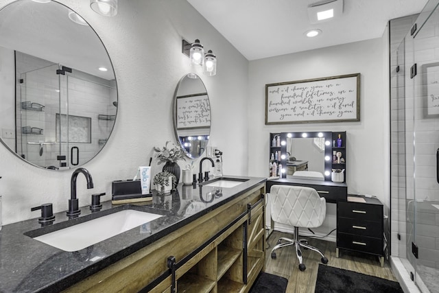 1985 Eastridge Ln, Madisonville, TX 77864 - full bath with a shower stall, a sink, and wood finished floors