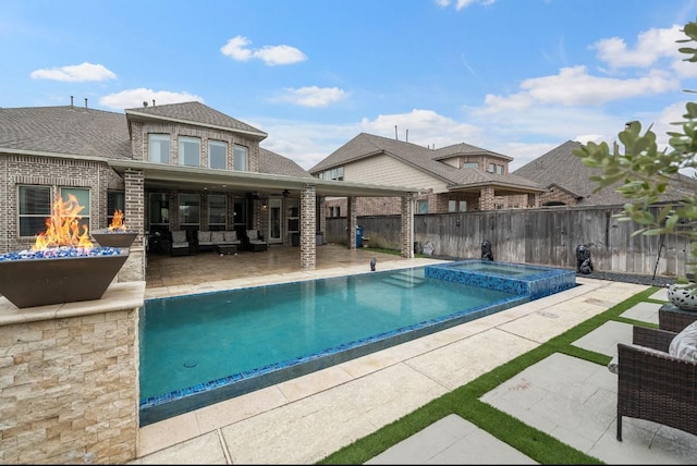 16202 Coyote Run Ln, Cypress, TX 77433 - view of swimming pool featuring a fire pit, a patio area, a fenced backyard, a ceiling fan, and a pool with connected hot tub