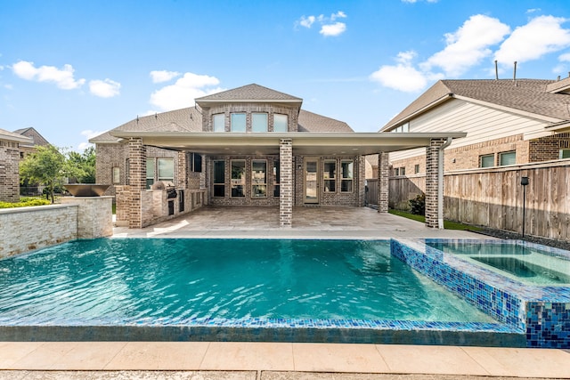 16202 Coyote Run Ln, Cypress, TX 77433 - view of pool featuring exterior kitchen, a patio, and a pool with connected hot tub