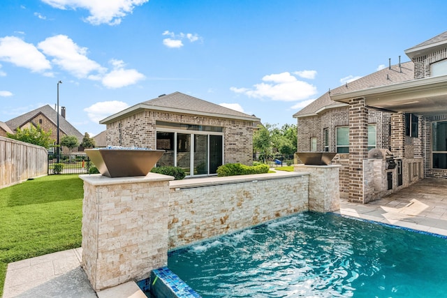 16202 Coyote Run Ln, Cypress, TX 77433 - view of pool featuring an outdoor kitchen and a patio area