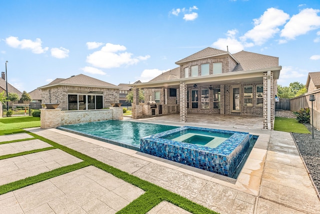 16202 Coyote Run Ln, Cypress, TX 77433 - view of swimming pool featuring a patio area, a fenced backyard, a pool with connected hot tub, and an outdoor structure