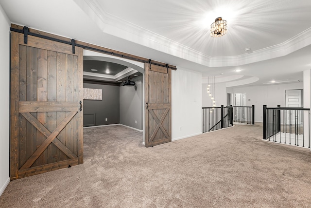 16202 Coyote Run Ln, Cypress, TX 77433 - unfurnished living room with a barn door, a raised ceiling, carpet, and crown molding