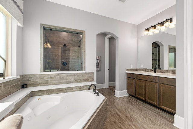 16202 Coyote Run Ln, Cypress, TX 77433 - bathroom with a jetted tub, vanity, a tile shower, and wood finished floors