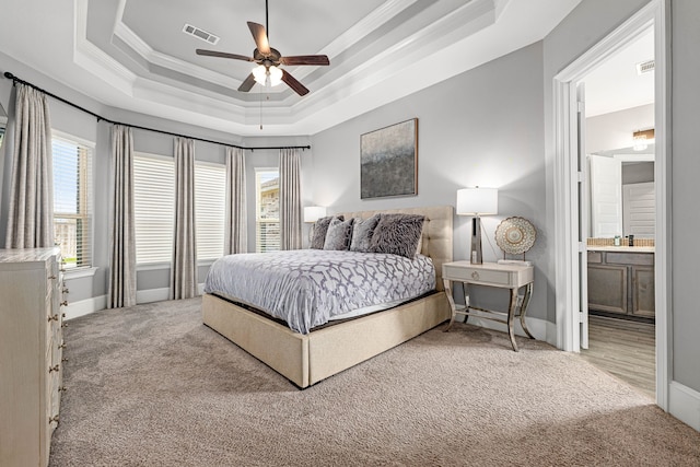 16202 Coyote Run Ln, Cypress, TX 77433 - carpeted bedroom featuring a raised ceiling, ornamental molding, multiple windows, ensuite bathroom, and ceiling fan