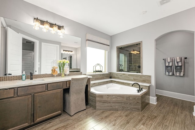 16202 Coyote Run Ln, Cypress, TX 77433 - full bathroom featuring a bath, vanity, and wood finished floors