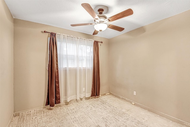 empty room featuring baseboards and ceiling fan