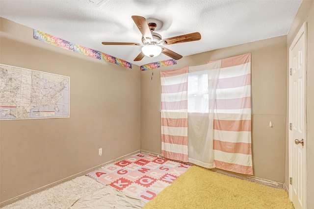 spare room featuring ceiling fan and a textured ceiling
