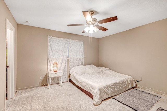 bedroom with baseboards and a ceiling fan