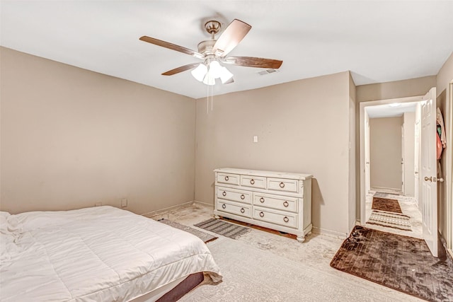bedroom with light colored carpet, ceiling fan, baseboards, and visible vents