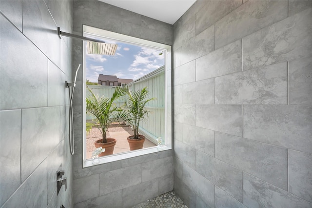 interior details featuring a tile shower