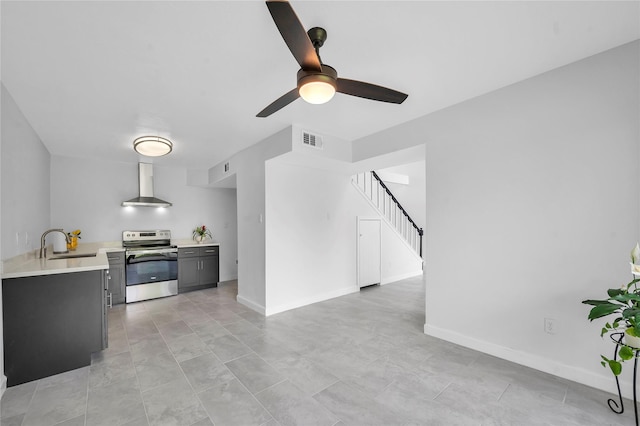 kitchen with a ceiling fan, visible vents, electric stove, wall chimney range hood, and light countertops