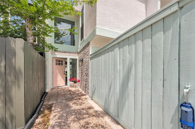 view of side of home featuring fence