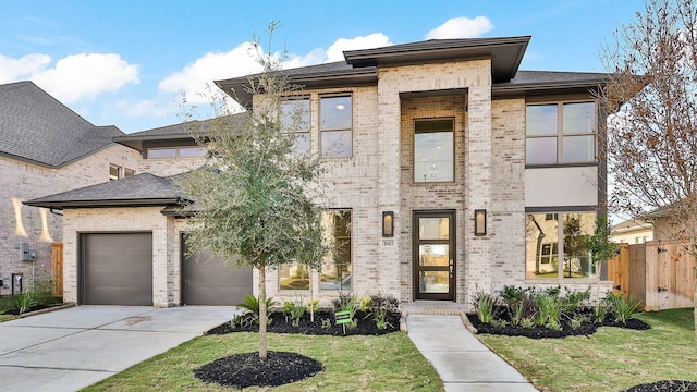 view of front of home featuring fence, a front yard, concrete driveway, and brick siding