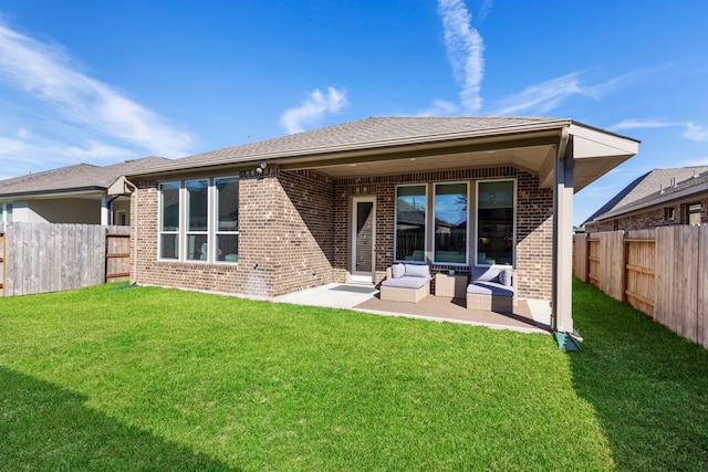 444 Texoma Plains Dr, Conroe, TX 77304 - back of house with a lawn, a patio, brick siding, and a fenced backyard
