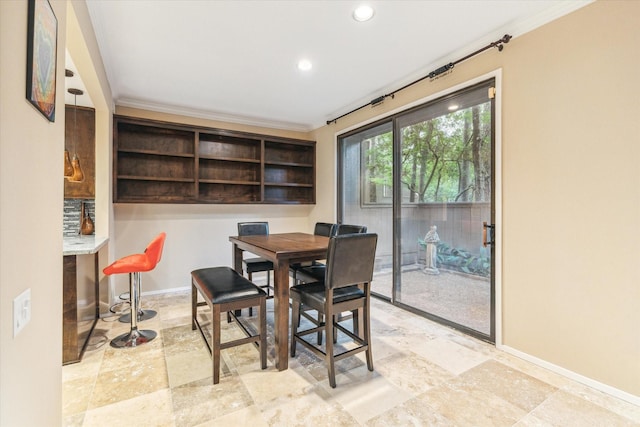 dining space with baseboards, crown molding, stone tile floors, and recessed lighting