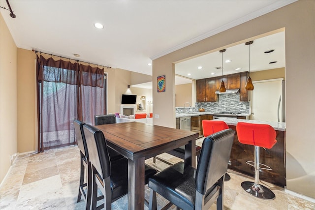 dining area featuring recessed lighting, baseboards, ornamental molding, and light stone finish floors