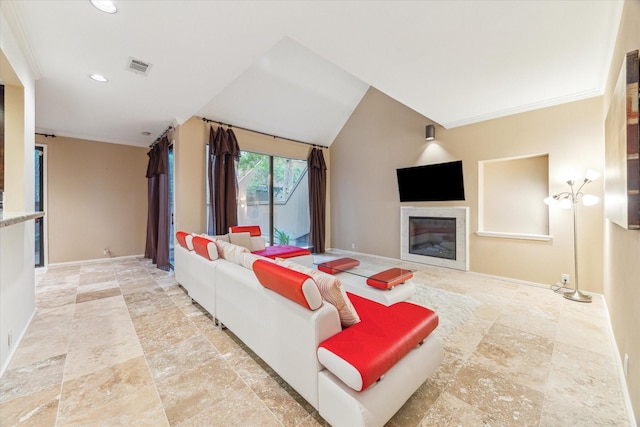 living room with stone tile flooring, baseboards, a glass covered fireplace, and recessed lighting