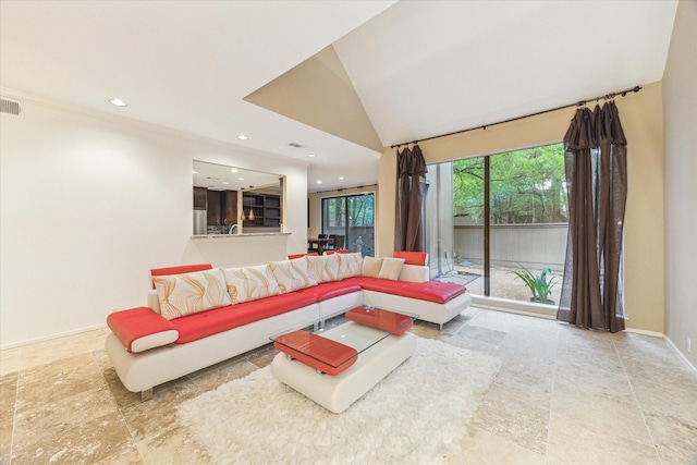 living area featuring recessed lighting and baseboards