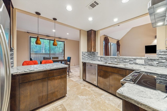 kitchen with appliances with stainless steel finishes, a sink, tasteful backsplash, light stone counters, and recessed lighting