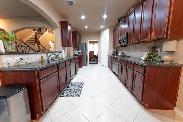 3519 Maverly Crest Ct, Katy, TX 77494 - kitchen with appliances with stainless steel finishes, a sink, arched walkways, decorative backsplash, and recessed lighting