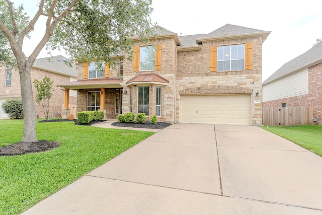 traditional-style house with a garage, driveway, brick siding, stone siding, and covered porch