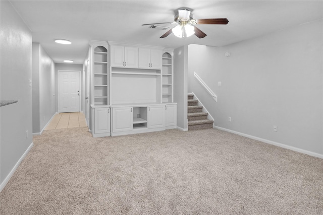 21618 Falvel Lake Dr, Spring, TX 77388 - unfurnished living room with stairway, baseboards, visible vents, ceiling fan, and light colored carpet