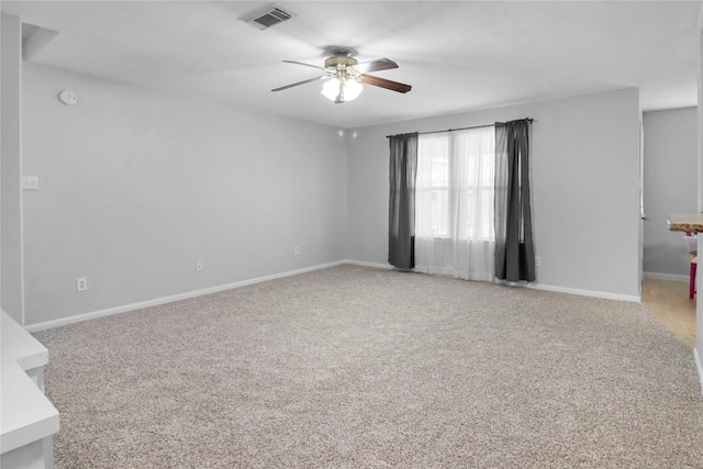 21618 Falvel Lake Dr, Spring, TX 77388 - spare room featuring light colored carpet, visible vents, baseboards, and ceiling fan