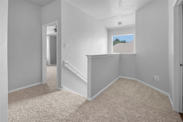 21618 Falvel Lake Dr, Spring, TX 77388 - corridor with a textured ceiling, an upstairs landing, baseboards, and carpet floors