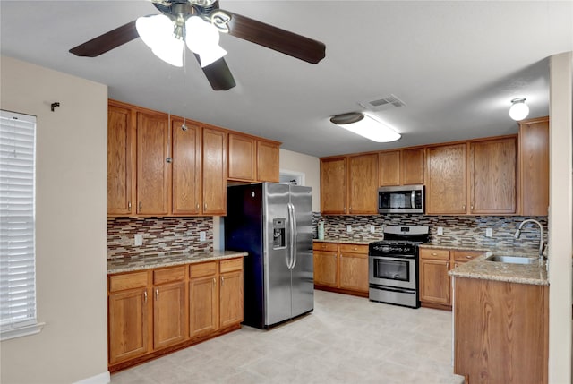 21618 Falvel Lake Dr, Spring, TX 77388 - kitchen featuring stainless steel appliances, tasteful backsplash, visible vents, and a sink
