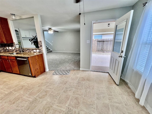 21618 Falvel Lake Dr, Spring, TX 77388 - kitchen with dishwashing machine, a sink, baseboards, light stone countertops, and decorative backsplash