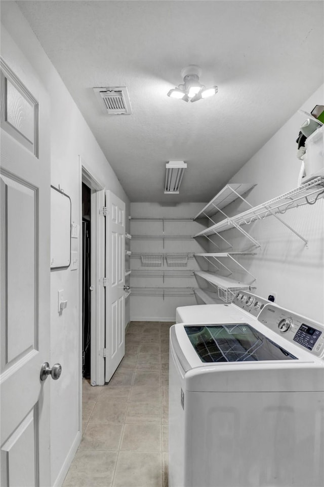 21618 Falvel Lake Dr, Spring, TX 77388 - laundry area with laundry area, light tile patterned floors, visible vents, and washer and dryer