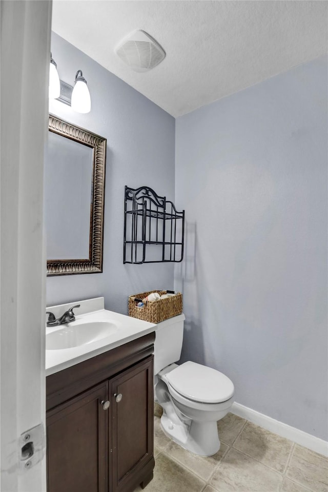 21618 Falvel Lake Dr, Spring, TX 77388 - half bath featuring vanity, toilet, baseboards, and tile patterned flooring