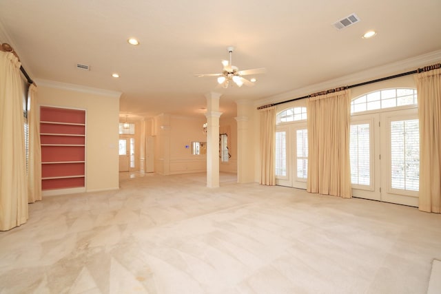 unfurnished living room featuring ornamental molding, decorative columns, light colored carpet, a ceiling fan, and recessed lighting