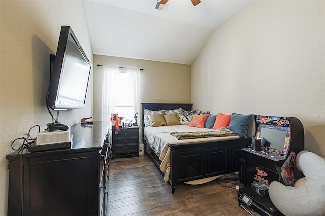 bedroom with vaulted ceiling, a ceiling fan, and dark wood finished floors